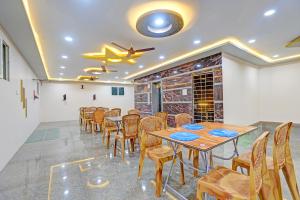 a dining room with a table and chairs at FabHotel Saravana Shelters Residency - Nr Tambaram Railway Station in Chennai