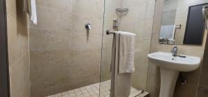 a bathroom with a sink and a toilet and a shower at Melrose Corner Self-Catering Hotel Apartments in Johannesburg +20 photos