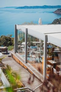 a view of the ocean from the deck of a restaurant at Hôtel La Villa Douce in Rayol-Canadel-sur-Mer