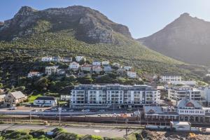 a view of a city with a mountain in the background at Modern One Bedroom Wavescapes Apartment Muizenberg in Muizenberg