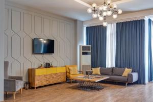 a living room with a couch and a table at Hotel Mevora in Tbilisi City