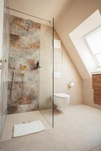 a bathroom with a shower and a toilet at beppo Restaurant Suites in Backnang