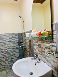a bathroom with a sink and a mirror at Fleurs d'Ylang in Nosy Be +19 photos