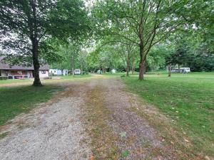 a dirt road in a park with trees at Camping Paradis Nature in Ivoy-le-Pré
