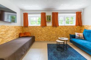 a living room with a bed and a couch at Apartamenty za Leśniczówką in Stegna