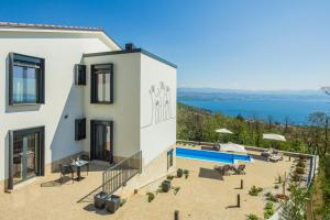 a villa with a view of the ocean at Villa Manus - Boutique Apartments in Lovran
