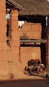 een persoon die in een raam van een bakstenen gebouw staat bij Tapenaka in Ambatolampy