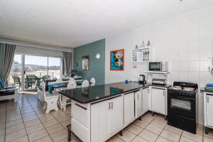 a kitchen with a counter and a table in it at Seagull 302 in Margate