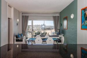 a living room with a table and chairs and a couch at Seagull 302 in Margate