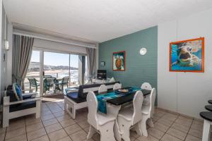 a dining room with a table and chairs and a view of the ocean at Seagull 302 in Margate