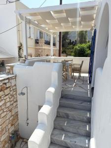a staircase leading to a patio with a table at Central Parikia stay-Helios in Parikia
