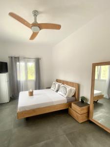 a bedroom with a bed with a ceiling fan at Central Parikia Stay in Parikia