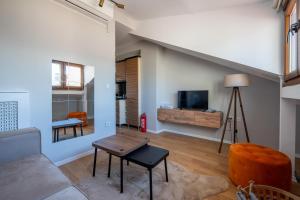 a living room with a couch and a tv at Raya Cihangir Suites in Istanbul