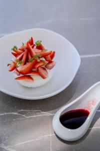 a plate of carrots on a table with a bowl of sauce at Hôtel La Villa Douce in Rayol-Canadel-sur-Mer
