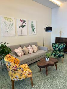 a living room with a couch and a chair at myROOM @ Mandalay Georgetown, Off Jln Burma, Gurney Drive in George Town
