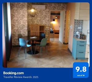 a kitchen and dining room with a table and chairs at Blonde River Apartman Móra Szeged in Szeged