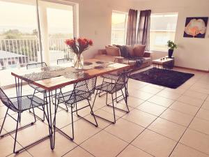 a living room with a table and chairs and a couch at Brackenfell self catering accommodation in Brackenfell