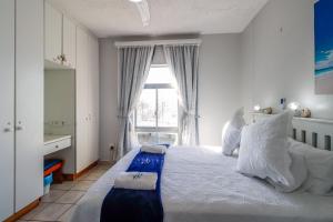 Postel nebo postele na pokoji v ubytování Seagull 303 + 8 fotografií