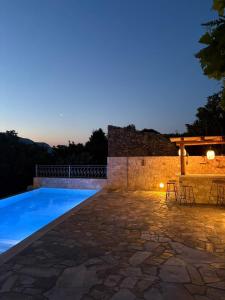 a villa with a swimming pool at night at Villa Iremia 