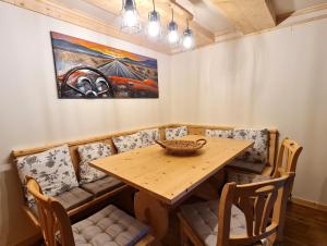 a dining room with a wooden table and chairs at Die Alte Scheune by Globalimmoservice in Bad Kleinkirchheim