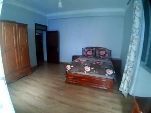 a bedroom with a bed and a wooden floor at Dar yahya in Chefchaouen