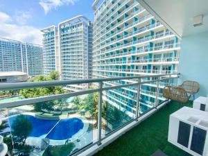 a balcony with a view of a large building at Azure Cozy Hotel by CM staycation in Manila