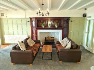 a living room with two couches and a fireplace at The Kensington in Great Yarmouth