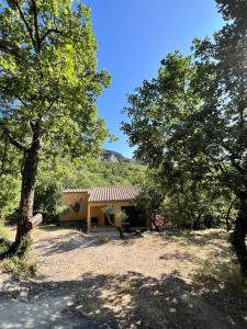 a house with trees in front of it at Cosy Home Stay in Mimet