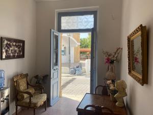 a room with an open door with a chair and a table at ToHaniMou - Kamara Medium Studio in Nicosia