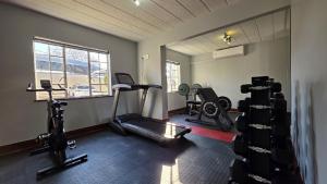 a gym with two treadmills and two bikes in a room at Melrose Corner Self-Catering Hotel Apartments in Johannesburg