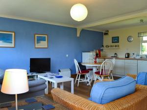 a living room with a couch and a table at Treyarnon in St Merryn