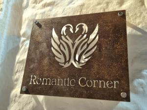 a sign for a rammable center on a bed at Romantic Corner in Alberobello