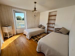 Ένα ή περισσότερα κρεβάτια σε δωμάτιο στο La Vigie - Maison en bord de mer