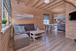 a living room with a couch and a table at Domki letniskowe Kajuta in Władysławowo