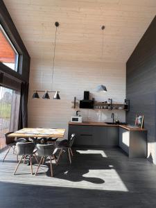a kitchen and dining room with a table and chairs at pro100 house in Volosyanka