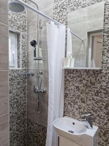 a bathroom with a white sink and a shower at Guest House Keskic in Karlobag +65 photos
