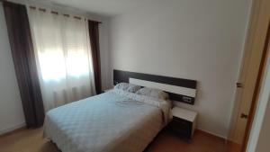 Ένα ή περισσότερα κρεβάτια σε δωμάτιο στο BENIVILLAGe
