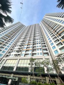 a tall white building with trees in front of it at Studio Sapphire Hạ Long View Biển in Ha Long