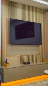 a flat screen tv hanging on a wall at Dunslim Apartments in Lusaka