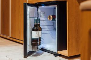 a bottle of wine in an open refrigerator at Penzion U Harmáčků in Hustopeče