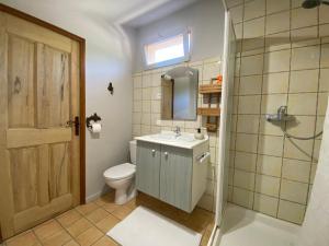 a bathroom with a toilet and a sink and a mirror at Villa Férus Piscine chauffée chambres d'hôtes in Buis-les-Baronnies