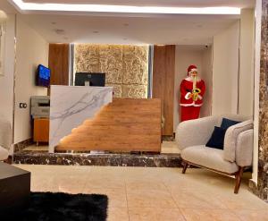 a santa claus is standing in a living room at New Museum, Pyramids inn in Cairo