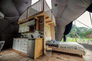 a kitchen in a large tent with a bed in it at Glamping nad Sanem in Krzemienna