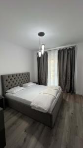 a bedroom with a large bed and a large window at Joy City Stay Mara M11-14 in Timişoara