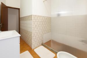 a bathroom with a toilet and a sink and a shower at Freedom Surf House in Serra de El-Rei