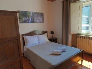 a bedroom with a bed with two towels on it at Casa Serradalto in Manteigas +28 photos