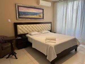 Ένα ή περισσότερα κρεβάτια σε δωμάτιο στο Cacique Hotel