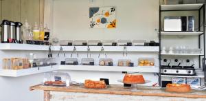 a kitchen with shelves with food on a table at Pousada Lírios do Campo in Paraty