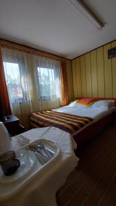 a hotel room with two beds and a sink at Nad Bałtykiem in Mrzeżyno +6 photos