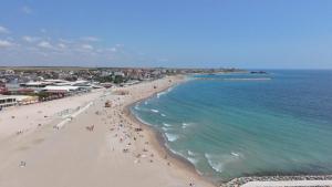 an overhead view of a beach with people and the ocean at Hostel Delfinul Albastru in Costinesti +203 photos